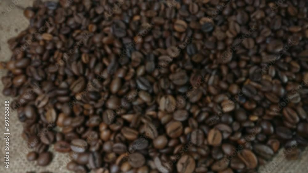 Great background of Roasted coffee beans on bagging close up. Zooming out. Footage will work great for any videos dealing with coffee shops, travel, hospitality and much more. Great background of Roasted coffee beans on bagging close up. Zooming out. Footage will work great for any videos dealing with coffee shops, travel, hospitality and much more.