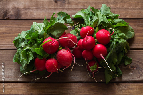 A bunch of radishes on a wooden table.