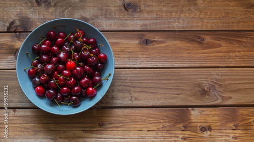 cherries on the wooden table with place for text