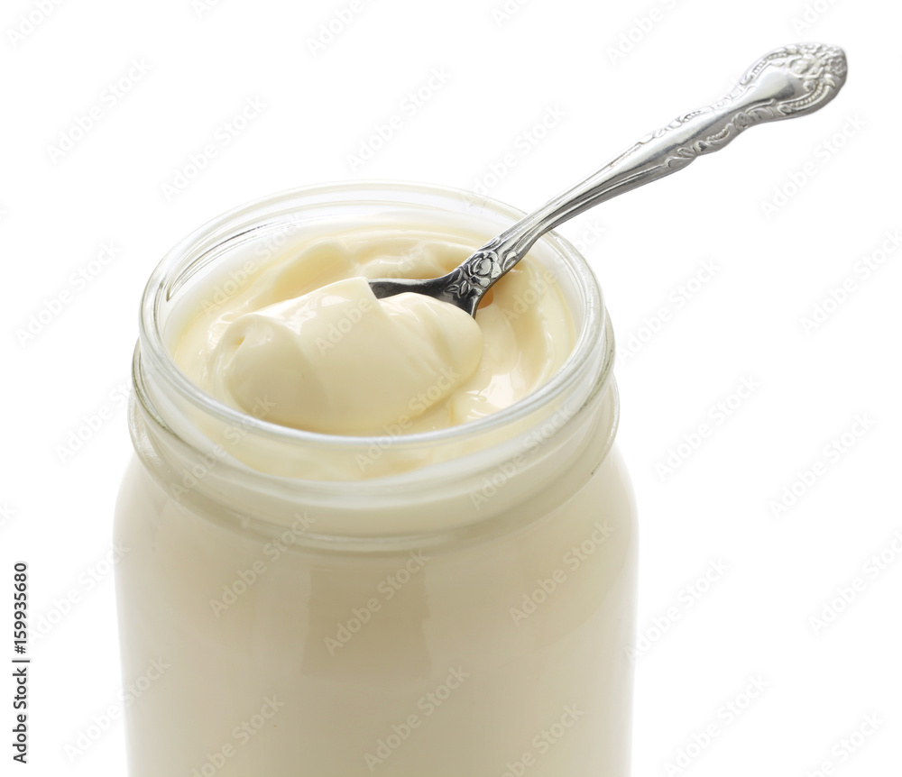 opened mayonnaise jar and spoon isolated on white background opened mayonnaise jar and spoon isolated on white background
