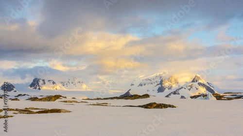Time lapse sunset in Antarctica. Mountains and alpine glow.