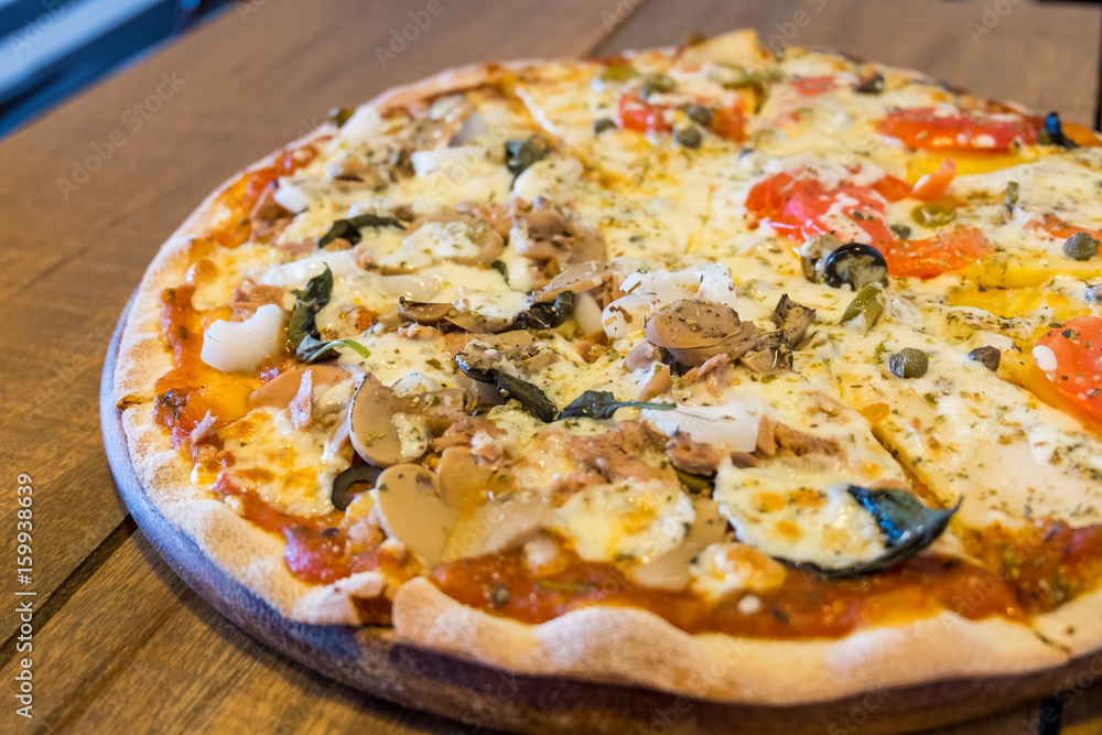 Italian pizza / close up vegetarian Italian pizza with mushroom and tuna on wooden table, Selective focus. Italian pizza / close up vegetarian Italian pizza with mushroom and tuna on wooden table, Selective focus.