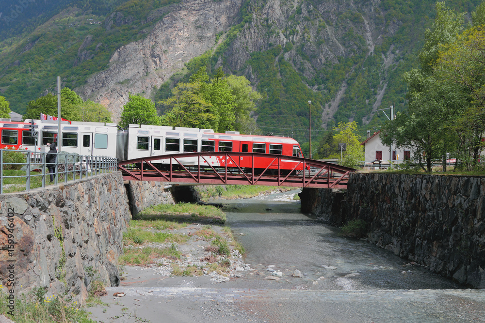 Naklejka premium Train, bridge and river Trient. Vernayaz, Martigny, Switzerland