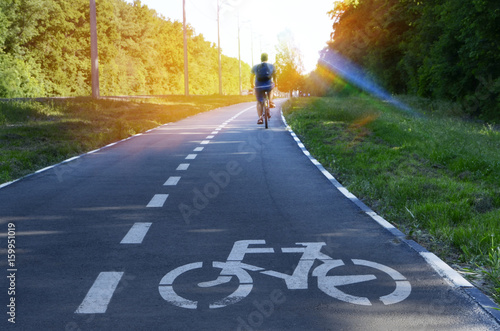 The bike path goes into the distance. A sign of a bicycle. Place for the inscription
