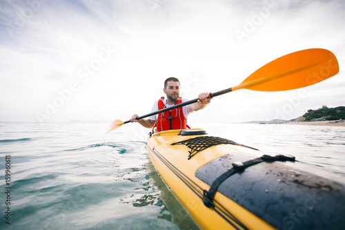 Man paddling sea kayak