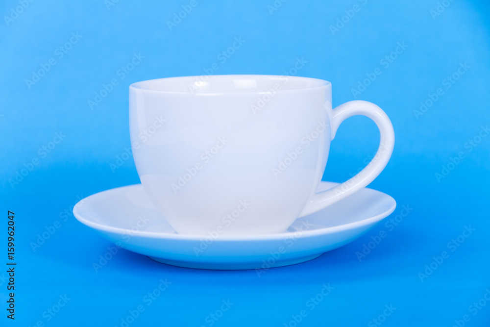 A white cup on blue background A white cup on blue background