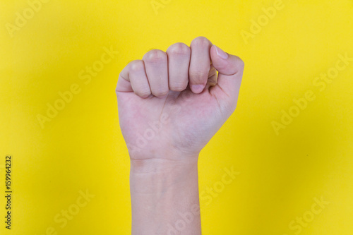 Close hand on yellow background