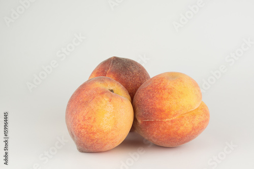 Three large ripe peaches