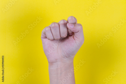 Close hand on yellow background