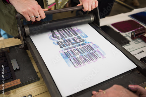 vintage  wooden antique analogue typeset letter blocks being prepared for block printing. photo