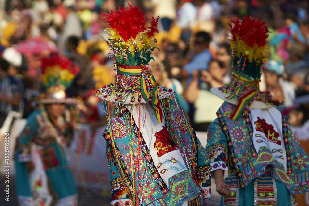 Tinkus dancing group in colourful costumes performing a traditional ritual dance as part of the Carnaval Andino con la Fuerza del Sol in Arica, Chile.