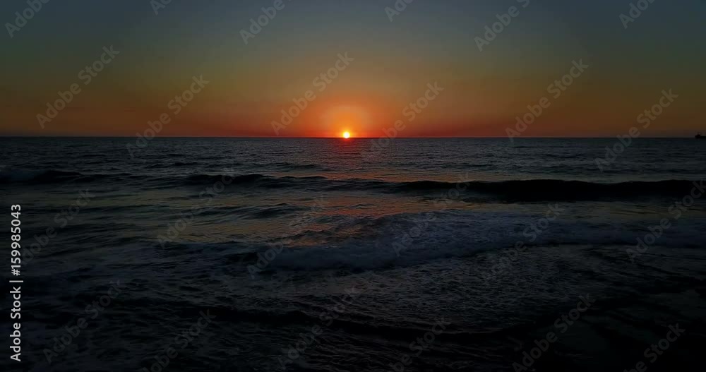 Brightly colored sunset over the calm Mediterranean Sea. Drone Point of View . Night Brightly colored sunset over the calm Mediterranean Sea. Drone Point of View . Night