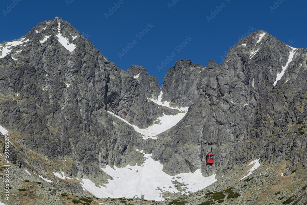 red cableway rising to the top in High Tatras red cableway rising to the top in High Tatras
