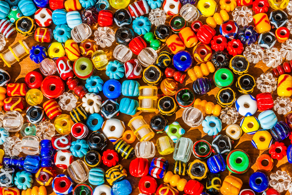 Colorful beads on a wooden surface