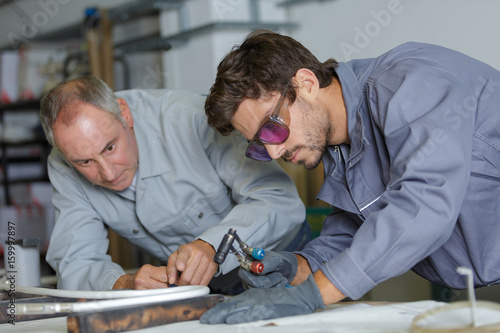 young man in professional training to become plumber