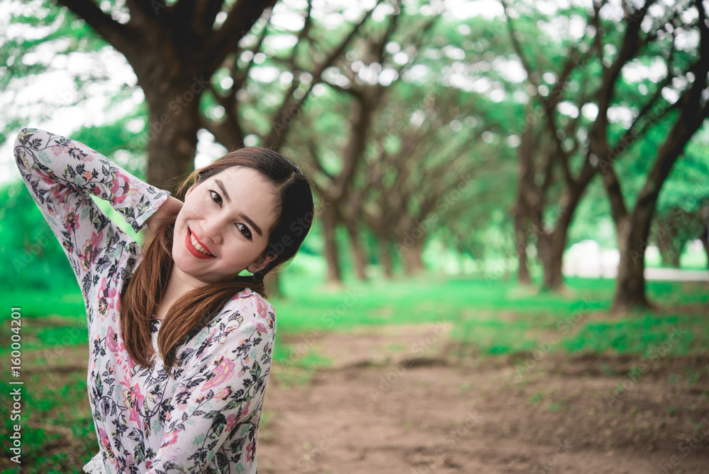 Portrait of Beautiful thai woman smile,sit on lawn use hand touch head under tunnel tree,sweet tone,pastel tone,vintage,film Portrait of Beautiful thai woman smile,sit on lawn use hand touch head under tunnel tree,sweet tone,pastel tone,vintage,film