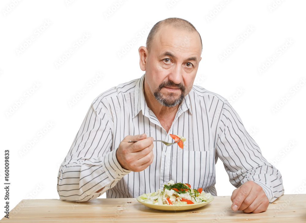 Man eating the salad with a raw vegetables Man eating the salad with a raw vegetables