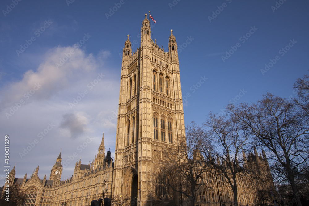 England's Parliament building with deep blue skies rises above Westminster with a glimpse of the famous Big Ben England's Parliament building with deep blue skies rises above Westminster with a glimpse of the famous Big Ben