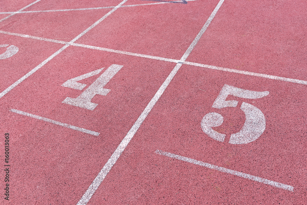 White Number five,four athletic track number on red rubber racetrack, texture of running racetracks in stadium