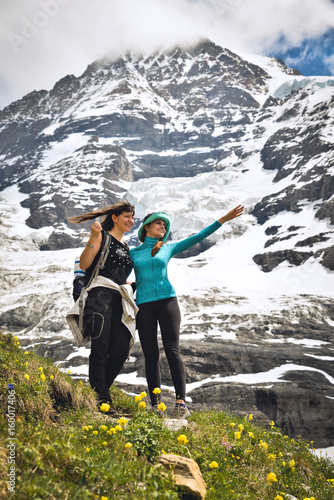 Two girls admiring the beauty of the Alps. Scenic landscape 