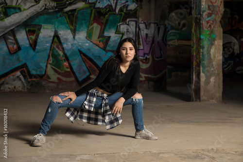 Hip hop dancer in front of graffiti wall