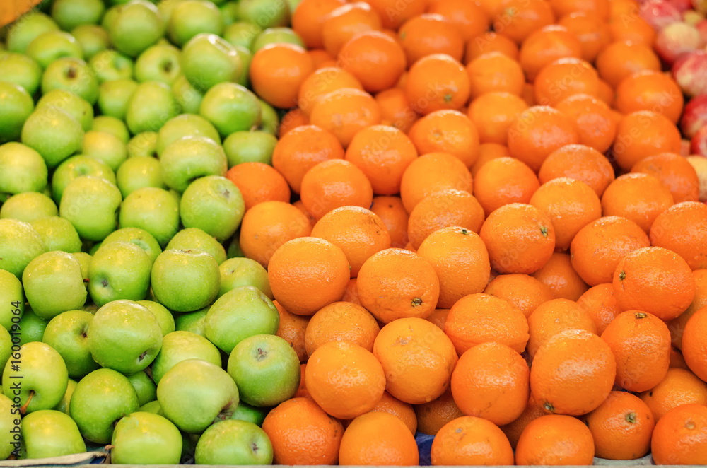 beautiful color combination, orange and green apple background display at market stall.