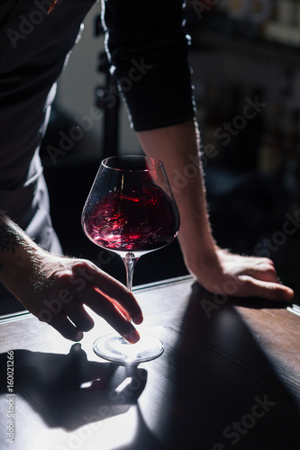 Man tasting new sorts of wine at the table
