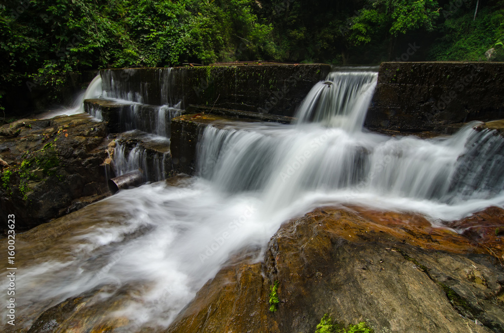 beautiful in nature, amazing cascading tropical waterfall. wet and mossy rock, surrounded by green rain forest beautiful in nature, amazing cascading tropical waterfall. wet and mossy rock, surrounded by green rain forest