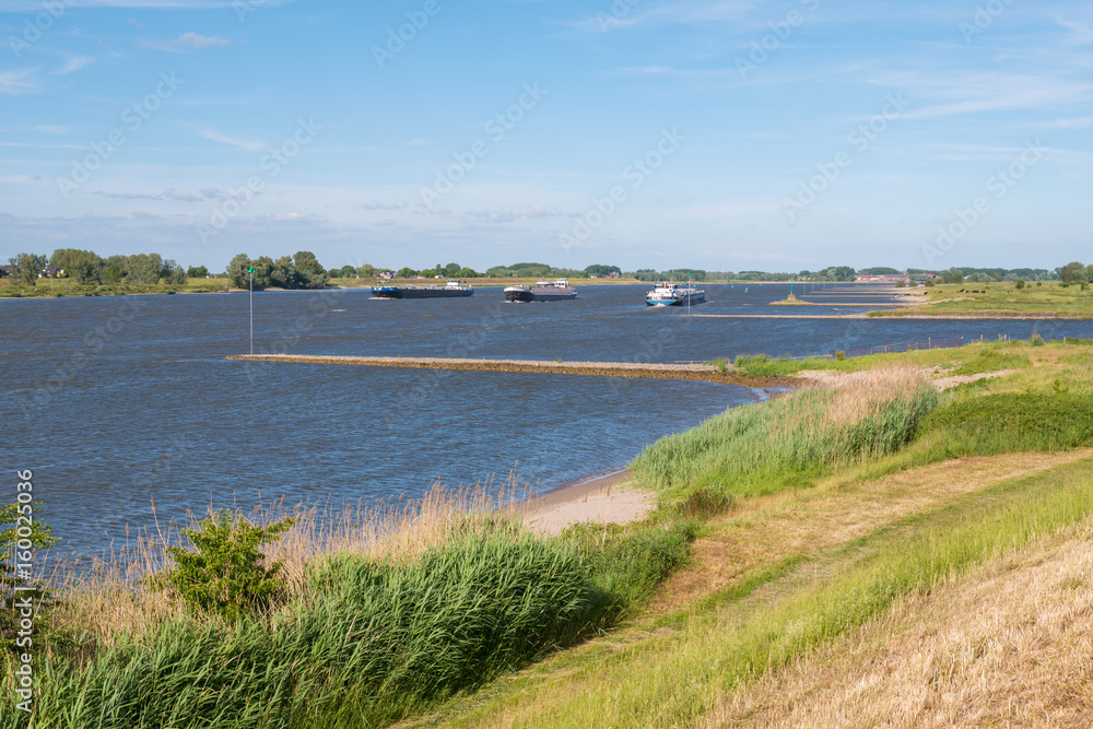 Waal river with groynes and inland shipping, Netherlands Waal river with groynes and inland shipping, Netherlands