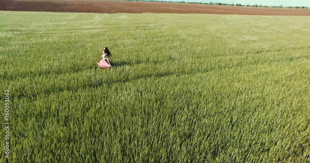 Young woman running through wheat field Young woman running through wheat field