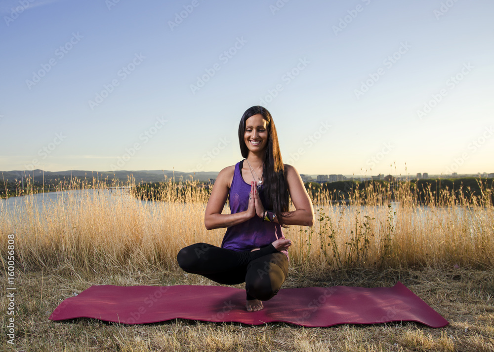 Happy energetic woman in yoga stretch and meditation pose, meditation on one leg