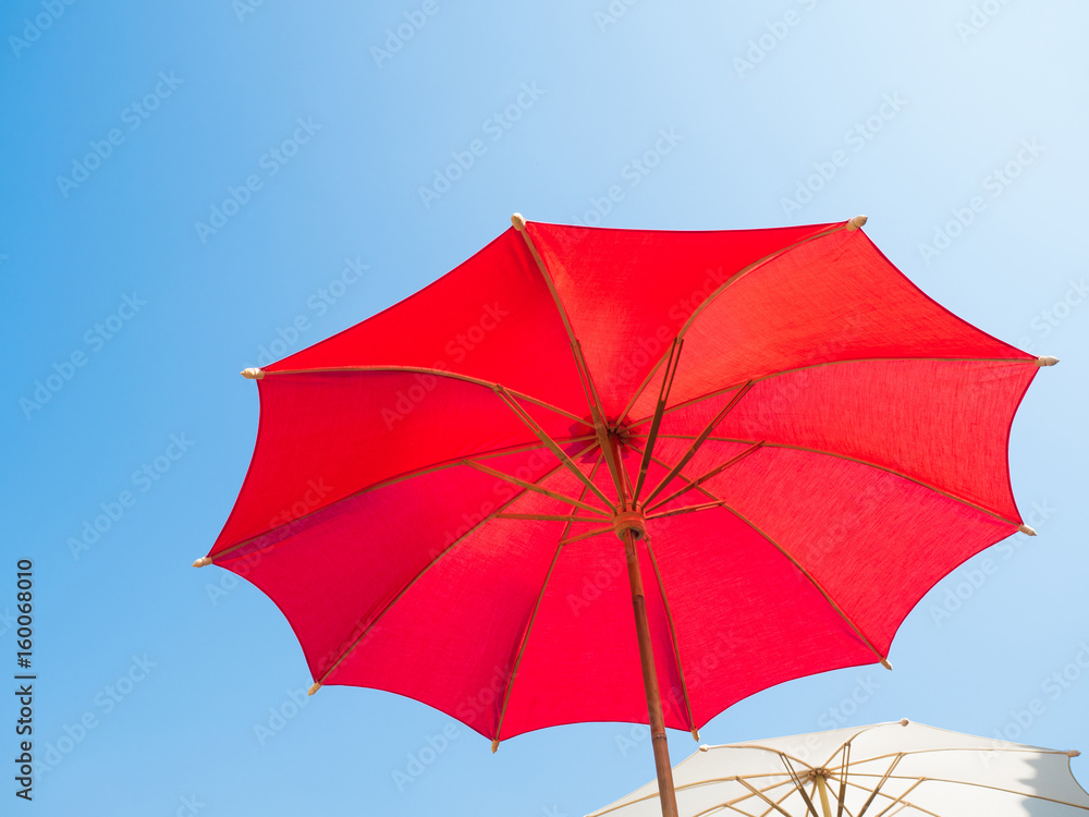 colorful umbrella with full spanned against blue sky