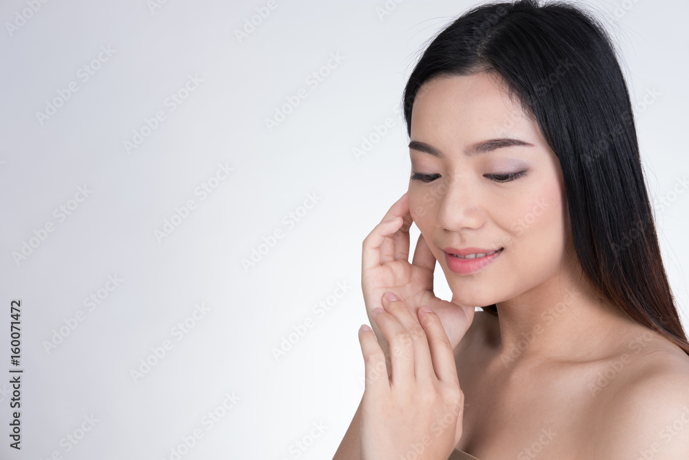 Portrait of a smiling young woman with natural make-up. beautiful asian girl standing against white background. Skincare, healthcare, studio shot. Portrait of a smiling young woman with natural make-up. beautiful asian girl standing against white background. Skincare, healthcare, studio shot.