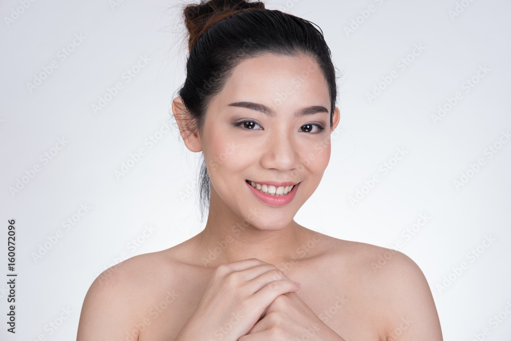 Portrait of a smiling young woman with natural make-up. beautiful asian girl standing against white background. Skincare, healthcare, studio shot. Portrait of a smiling young woman with natural make-up. beautiful asian girl standing against white background. Skincare, healthcare, studio shot.