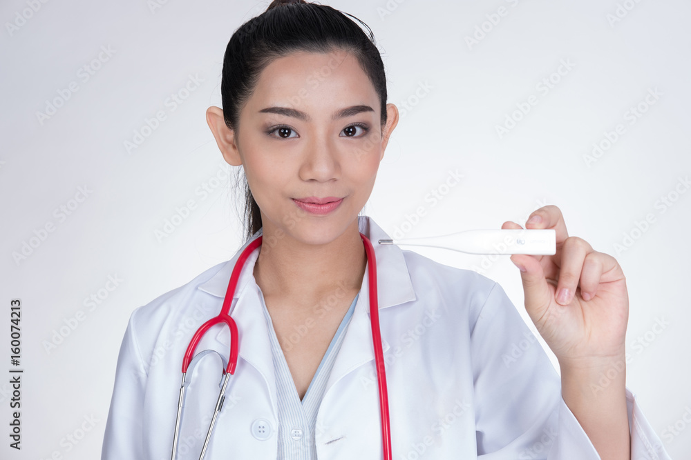 Confident smiling female doctor with electronic body thermometer in hand. Portrait of a young medical staff, physician or practitioner on white background Confident smiling female doctor with electronic body thermometer in hand. Portrait of a young medical staff, physician or practitioner on white background