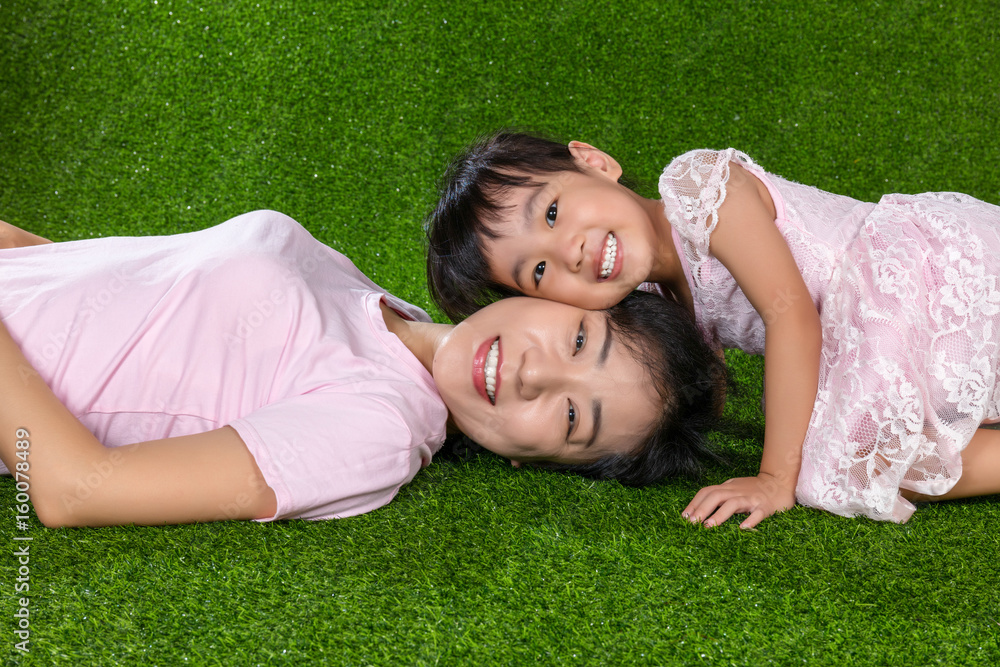 Asian Chinese mother and daughter looking at camera and smiling Asian Chinese mother and daughter looking at camera and smiling
