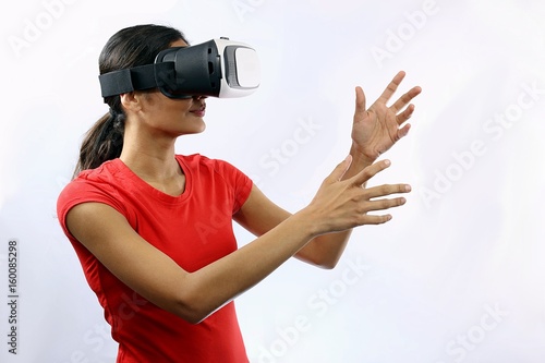 Attractive young woman wearing virtual reality goggles