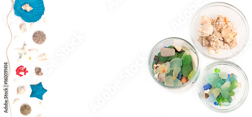 colored pebbles in a glass Cup on white background