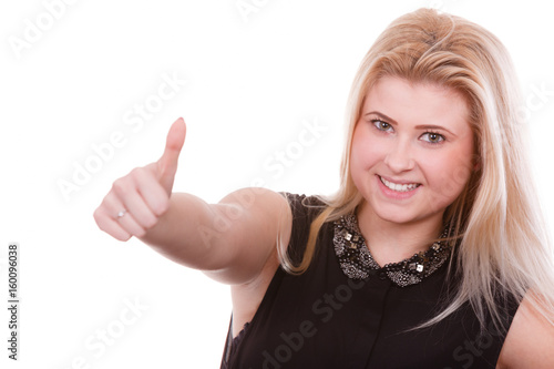 Smiling blonde woman making thumb up gesture