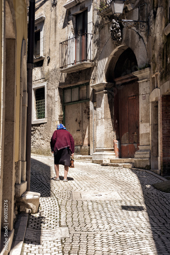 Old lonely woman in the street © zenzaetr