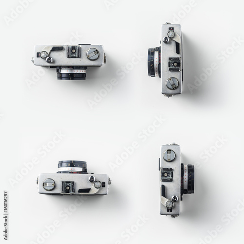 Top view of vintage cameras on white background desk for mockup, collection of diverse angle. photo