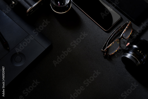 Designer desk mockup. Desk, Camera - Photographic Equipment, Smart Phone on dark top table. photo