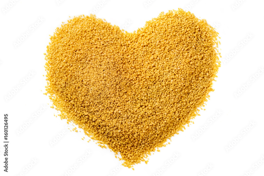 Heart made of couscous, shot from above on white Heart made of couscous, shot from above on white