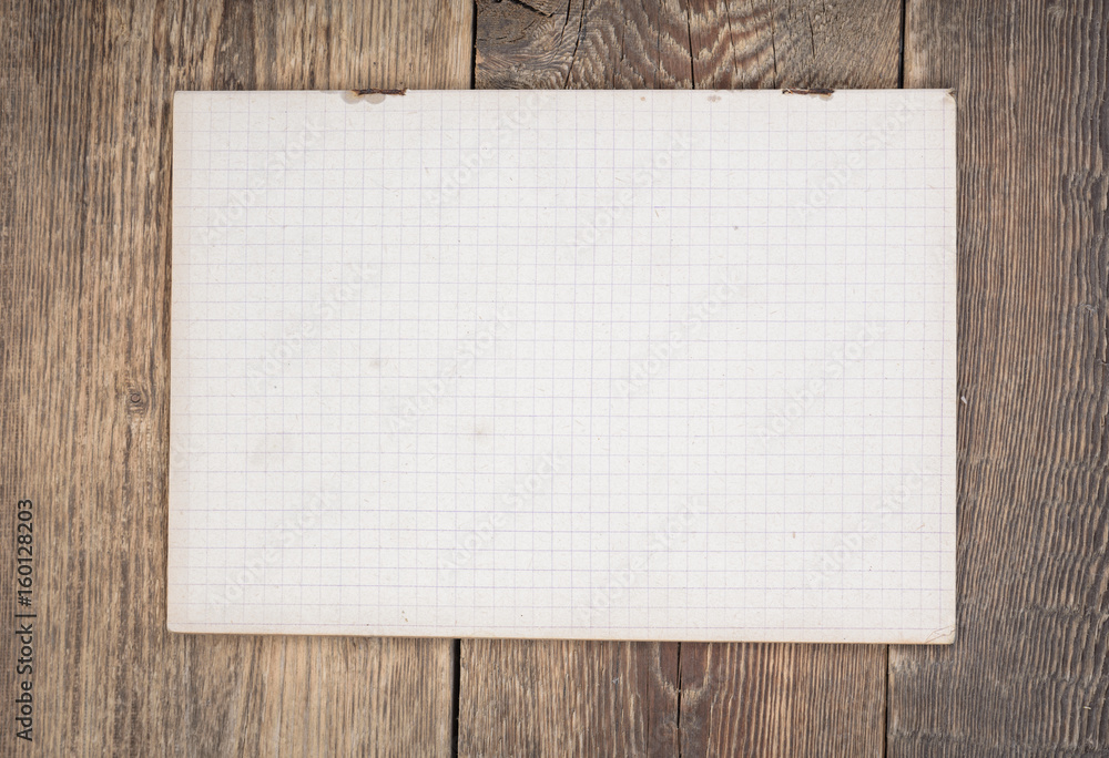 Notebook paper on wood background.Top view. Notebook paper on wood background.Top view.