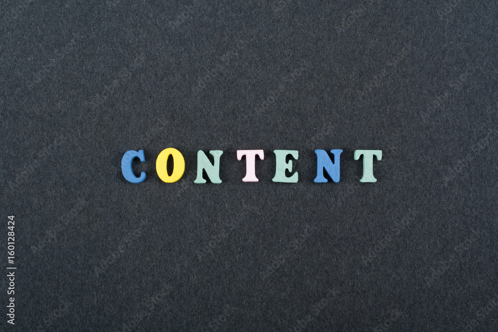 CONTENT word on black board background composed from colorful abc alphabet block wooden letters, copy space for ad text. Learning english concept. CONTENT word on black board background composed from colorful abc alphabet block wooden letters, copy space for ad text. Learning english concept.