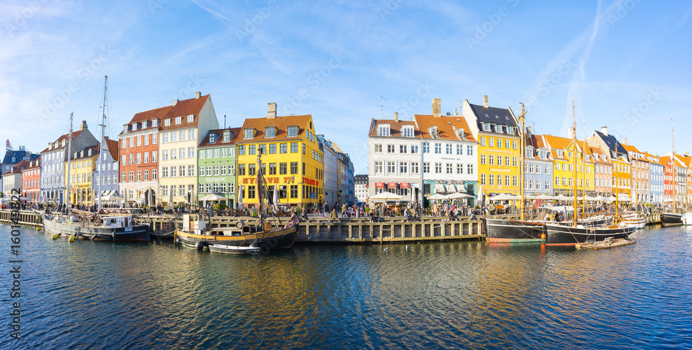 Nyhavn with its picturesque harbor and colorful facades of old houses in Copenhagen, Denmark