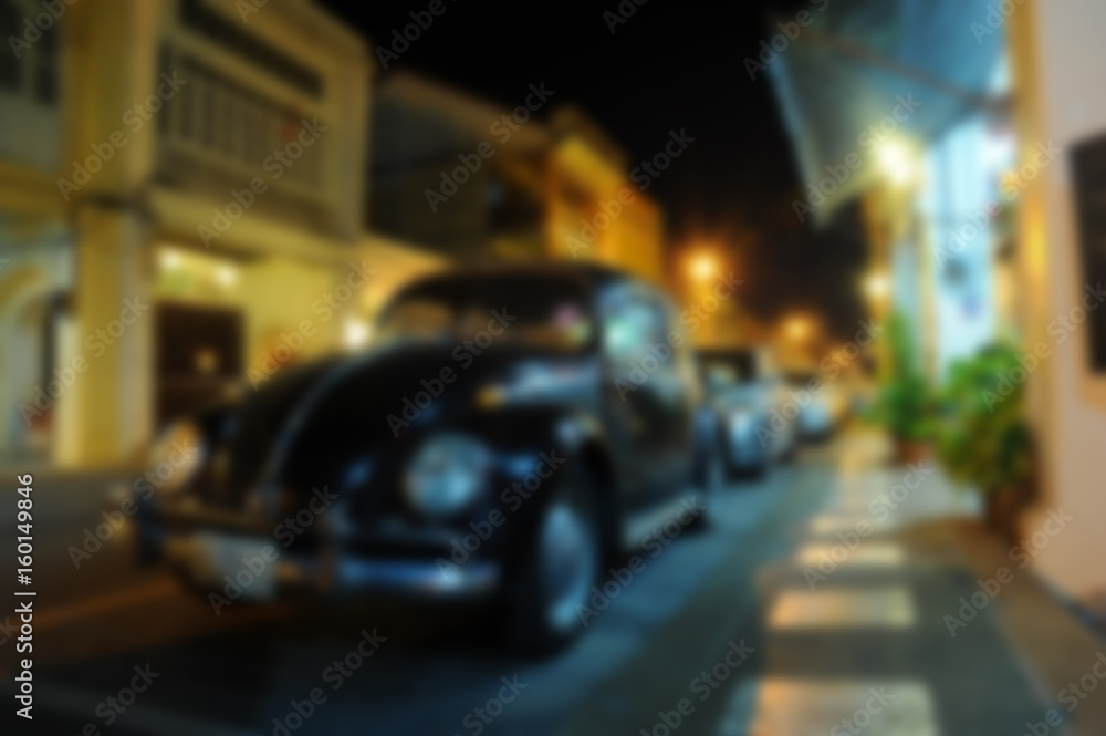 blurred parking car on night street of city background