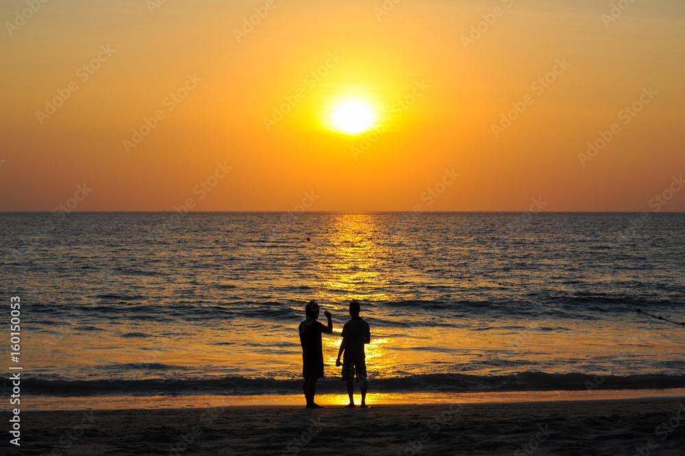 Beautiful Sunset at andaman sea with silhouette people together