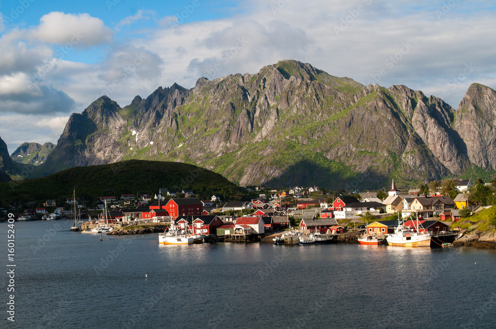 Reine, Lofoten, Norway - a small fishing town on the shore of the sea under a high mountain.