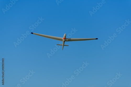 Sailplane pulled up in the sky on a line from a skylauncher